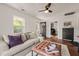 Comfortable living room features a sofa, patterned rug, modern furniture, and bright windows at 12601 Boyce Mill Rd, Raleigh, NC 27613