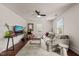 Bright living room featuring a sofa, stylish rug, modern furniture, and a ceiling fan at 12601 Boyce Mill Rd, Raleigh, NC 27613