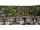 Aerial view of homes surrounded by lush greenery and mature trees in a neighborhood at 1265 Meadow Queen Ln, Apex, NC 27502