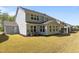 Spacious backyard view featuring a two-story home with a screened porch and lawn at 1265 Meadow Queen Ln, Apex, NC 27502