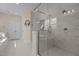 Bathroom with marble tile, glass shower, and white trim at 1265 Meadow Queen Ln, Apex, NC 27502