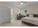 Bedroom features a ceiling fan, a large window and access to the bathroom at 1265 Meadow Queen Ln, Apex, NC 27502