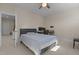 Neutral bedroom features a ceiling fan, work desk and a cozy gray bed at 1265 Meadow Queen Ln, Apex, NC 27502