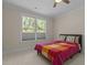 Cozy bedroom with a large window offering natural light and a colorful quilt at 1265 Meadow Queen Ln, Apex, NC 27502