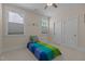 Bedroom featuring a ceiling fan, windows with blinds, and closet access at 1265 Meadow Queen Ln, Apex, NC 27502