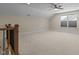 Spacious bonus room with natural light and carpet flooring, ideal for entertaining at 1265 Meadow Queen Ln, Apex, NC 27502