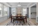 Dining room with natural light, modern chandelier, and wood dining table at 1265 Meadow Queen Ln, Apex, NC 27502