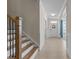 Welcoming entryway with wood staircase and paneled walls leading to the front door at 1265 Meadow Queen Ln, Apex, NC 27502