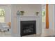 Fireplace with elegant mantle, flanked by windows, creates a cozy atmosphere at 1265 Meadow Queen Ln, Apex, NC 27502