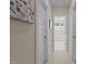 Hallway view with white doors and trim leading to a bright bathroom with tub at 1265 Meadow Queen Ln, Apex, NC 27502