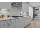 Bright kitchen featuring stainless steel appliances, white cabinets, and a modern backsplash at 1265 Meadow Queen Ln, Apex, NC 27502