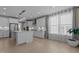 Open kitchen with stainless steel appliances, center island, and hardwood floors at 1265 Meadow Queen Ln, Apex, NC 27502