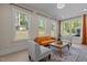 Bright living room with large windows, hardwood floors, and stylish furniture at 1265 Meadow Queen Ln, Apex, NC 27502