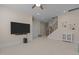 Large living area with entertainment center, ceiling fan, and stairway access at 1265 Meadow Queen Ln, Apex, NC 27502