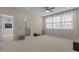 This living room features large windows, a ceiling fan, and access to a bath at 1265 Meadow Queen Ln, Apex, NC 27502