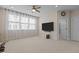 Spacious living room with large windows, a ceiling fan, and an entertainment center at 1265 Meadow Queen Ln, Apex, NC 27502