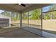 Inviting screened porch with ceiling fan overlooks a spacious lawn and lush landscaping at 1265 Meadow Queen Ln, Apex, NC 27502