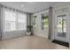 Bright sunroom with large windows and light hardwood floors at 1265 Meadow Queen Ln, Apex, NC 27502