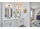 Bright bathroom with double vanity, white cabinets, modern fixtures, and stylish decor at 1336 Courtland Dr, Raleigh, NC 27604