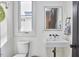 Chic half bathroom featuring a modern sink, sleek fixtures, and a bright, well-lit space with a window at 1336 Courtland Dr, Raleigh, NC 27604