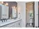 Modern bathroom with sleek tile, double sinks, minimalist fixtures, and a connected shower at 1336 Courtland Dr, Raleigh, NC 27604