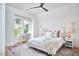 Bright bedroom features large windows, light-colored walls, ceiling fan and a comfortable, stylish decor at 1336 Courtland Dr, Raleigh, NC 27604