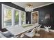 Contemporary dining room featuring sleek dark walls, hardwood floors, a modern light fixture, and spacious table at 1336 Courtland Dr, Raleigh, NC 27604