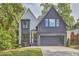 Charming two-story home featuring a modern gray and white exterior, well-manicured lawn, and attached garage at 1336 Courtland Dr, Raleigh, NC 27604