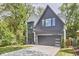 Stylish two-story home featuring modern gray and white exterior finishes, a paved driveway, and a well-maintained lawn at 1336 Courtland Dr, Raleigh, NC 27604