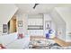 Cozy living room area with wet bar, sleek white cabinets, and comfortable furnishings at 1336 Courtland Dr, Raleigh, NC 27604