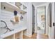Well-organized mudroom with custom built-in shelving, bench seating, and access to a conveniently located half bathroom at 1336 Courtland Dr, Raleigh, NC 27604
