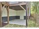 Under-deck patio featuring stone pavers, grass, and access to the backyard at 1336 Courtland Dr, Raleigh, NC 27604