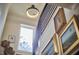 Close up view of staircase featuring artwork, modern railing and natural light from nearby window at 1336 Courtland Dr, Raleigh, NC 27604