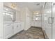Well-lit bathroom featuring dual sinks, granite countertops, a glass-enclosed shower, and tile floors at 134 Ivy Ridge Rd, Chapel Hill, NC 27516