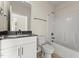 Bathroom featuring a single vanity, toilet, and shower-tub combo with white tile at 134 Ivy Ridge Rd, Chapel Hill, NC 27516