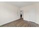 Neutral bedroom with wood floors, two doors, and electrical outlets at 134 Ivy Ridge Rd, Chapel Hill, NC 27516