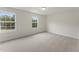 Bright bedroom with neutral carpet, fresh paint, and two windows letting in natural light at 134 Ivy Ridge Rd, Chapel Hill, NC 27516