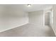 Bright bedroom with neutral carpet, baseboards, and multiple doorways at 134 Ivy Ridge Rd, Chapel Hill, NC 27516
