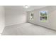 Bright bedroom with neutral carpet, baseboards, and dual windows allowing natural light at 134 Ivy Ridge Rd, Chapel Hill, NC 27516
