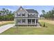 Charming two-story home with gray siding, black shutters, and inviting front porch, landscaped with a well-maintained lawn at 134 Ivy Ridge Rd, Chapel Hill, NC 27516
