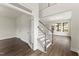 Bright entryway featuring hardwood floors, elegant staircase, and glass-paneled office doors at 134 Ivy Ridge Rd, Chapel Hill, NC 27516