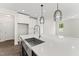 Kitchen island with modern pendant lights, stainless steel sink and faucet at 134 Ivy Ridge Rd, Chapel Hill, NC 27516
