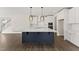 Spacious kitchen with white cabinets, modern appliances, and a large blue kitchen island at 134 Ivy Ridge Rd, Chapel Hill, NC 27516