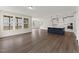 Open-concept living space featuring hardwood floors, large windows, and a modern kitchen at 134 Ivy Ridge Rd, Chapel Hill, NC 27516