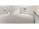 Spacious upstairs loft area with plush gray carpet, large windows, and natural light at 134 Ivy Ridge Rd, Chapel Hill, NC 27516
