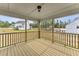 Covered porch boasts wood flooring and railing with views of the surrounding lawn at 134 Ivy Ridge Rd, Chapel Hill, NC 27516