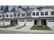 Charming townhomes boast manicured lawns, inviting garages, and stylish architectural details at 143 Rolesville Ridge Dr, Rolesville, NC 27571