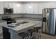 Modern kitchen features stainless steel appliances, granite countertops, and a functional island at 143 Rolesville Ridge Dr, Rolesville, NC 27571