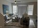 Cozy living room featuring modern furniture, plush rug, and lots of natural light at 143 Rolesville Ridge Dr, Rolesville, NC 27571