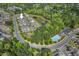 Aerial view of community showcasing the property's location near a pond, pool, and green spaces at 15 Plumas Drive Dr, Durham, NC 27705